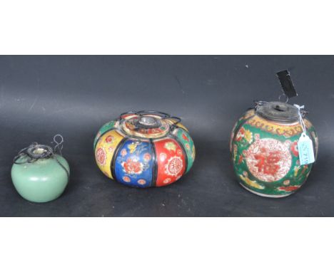 An assortment of three Chinese Qianlong ceramic oil lamps. Two having hand painted floral panels and the other decorated in a