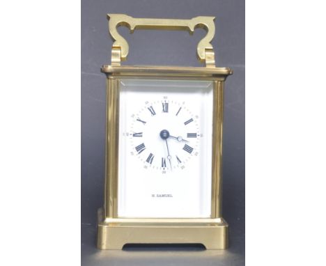 A vintage 20th century H. Samuel carriage 11 jewels clock. The clock having a black face with roman numeral to the chapter ri