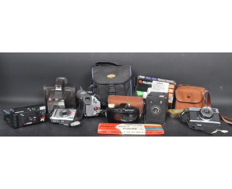 A collection of vintage 20th century cameras and photographic equipment to include a Canon MV200 video camcorder, a Finepix F