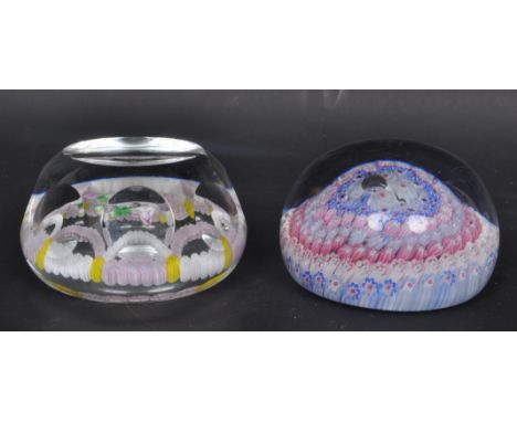 A pair of vintage 20th century glass paperweights of domed form with millefiori decoration and floral lamp work to centre.&nb