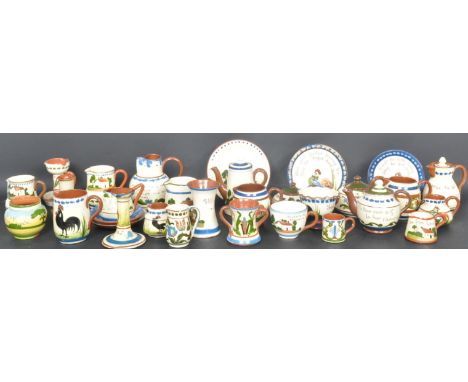 A large collection of 20th century Torquay Ware / mottoware to include cups and saucers, puzzle jugs, vases, egg cups, bowls.