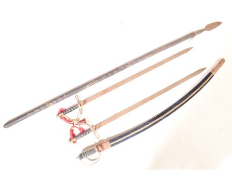 A collection of three vintage 20th century weapons comprising of 19th century Indian style swords having. Together with a Tri