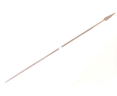 An African tribal spear. Carved stem with tapering end having wrought metal speak head, the end with reeded geometric design.