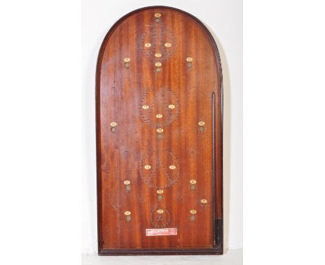 An early 20th Century original oak Corinthian Bagatelle game. With metal cups and scoring numbers. Plaque at the bottom of th