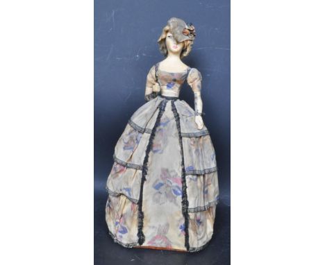 An early 20th century Art Deco doll / lamp having opposable arms, painted features, fabric dress raised on a wire frame. Meas