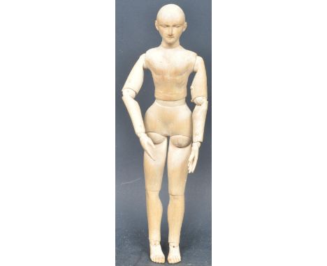 An early 20th century circa. 1940's carved wood artists mannequin having articulated limbs and carved facial features and ear