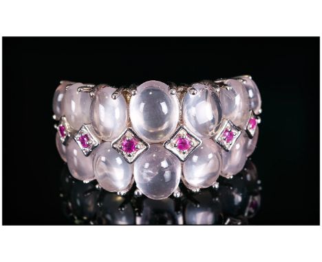 Rose Quartz and Ruby Ring, two rows of graduated, oval cut rose quartz cabochons, set across the finger, with round cut rubie