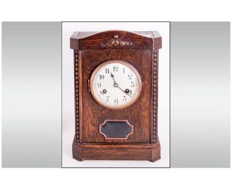 German Oak Cased Mantle Clock in the 1920's style with a round steel dial and exposed pendulum window. Makers Junghans Wurten