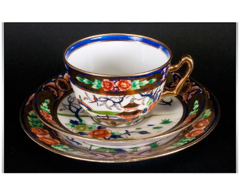 Noritake Trio comprising cup, saucer and side plate, gilded in the Imari style pattern. 