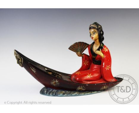 An early 20th century novelty plaster lamp, modelled as a Geisha in a boat, 44cm long, with a pair of Edwardian cast brass ga