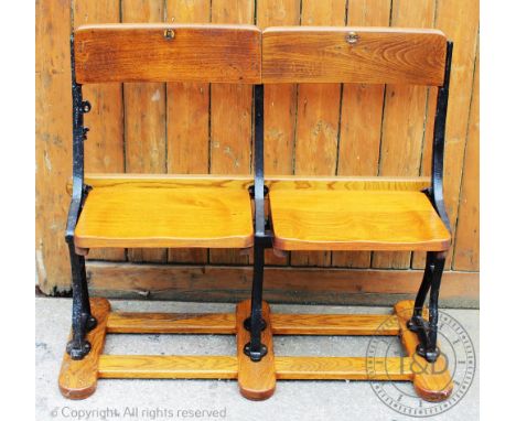 Stoke City Football Club - a section of two vintage seats, cast iron and wood, the side rail cast 'No 5 SCFC', seat numbered 