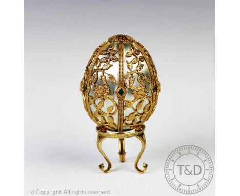 A Franklin Mint 'The Emergence of Spring' silver gilt egg in the manner of Faberge, London 1978, No.599/750, the egg of typic
