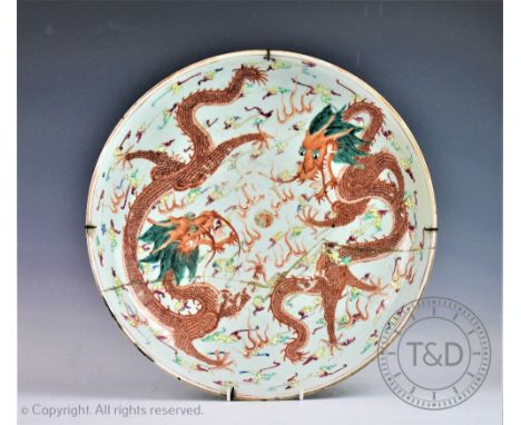 A large Chinese porcelain dragon charger, 19th century, the charger of circular shape decorated with two iron-red five clawed