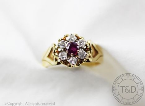 A diamond and untested ruby set ring, London 1978, designed as a central circular cluster of an untested ruby within a surrou