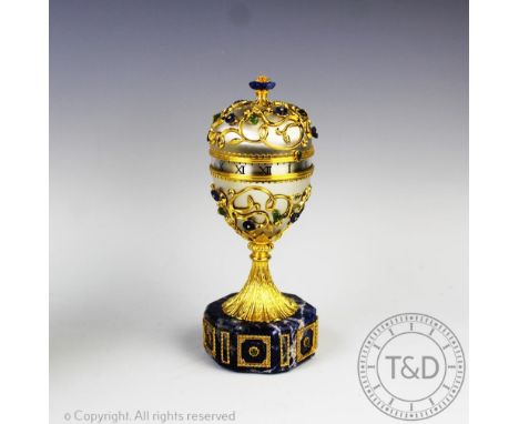 An Igor Carl Faberge Imperial clock, the table clock of egg form enclosing a roman numeral dial and mounted with gilt metal f