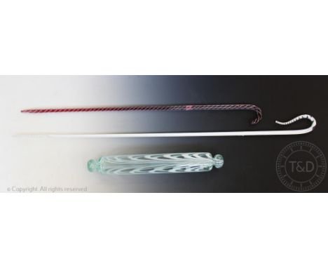 A Nailsea glass rolling pin, in clear and opaque white, 44cm long with two Victorian glass walking canes, with internal spira