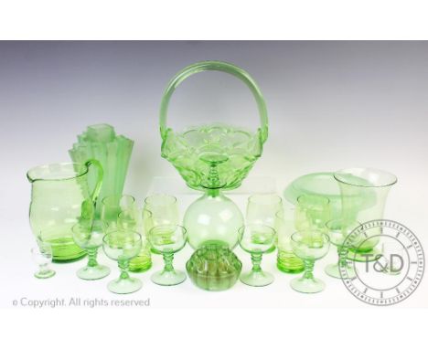 An Art Deco green glass decanter set, comprising a decanter and stopper and six glasses each with bobbin stems, a similar lem