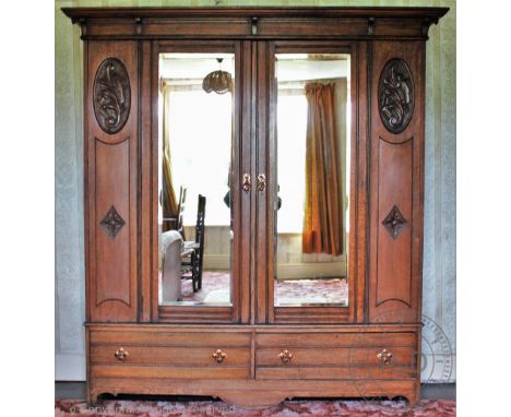 An Arts and Crafts oak dressing table, with mirror back and two drawers above two short and two long drawers, on turned legs,