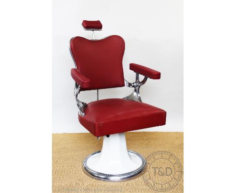 A vintage barbers chair, possibly 1950's, with chrome frame and red leatherette upholstery, on circular base, 100cm H