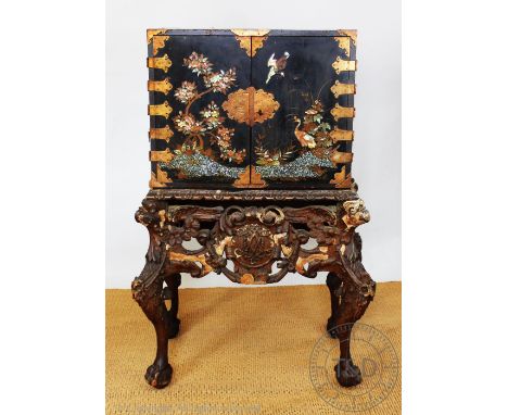 A Baroque style lacquered cabinet on stand, 19th century, the cabinet decorated with blossom trees and birds with mother of p