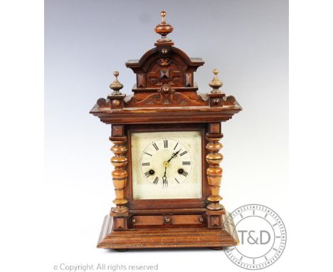 A German walnut eight day mantel clock, with Roman numeral dial and Jungens movement striking on a gong, 45cm high