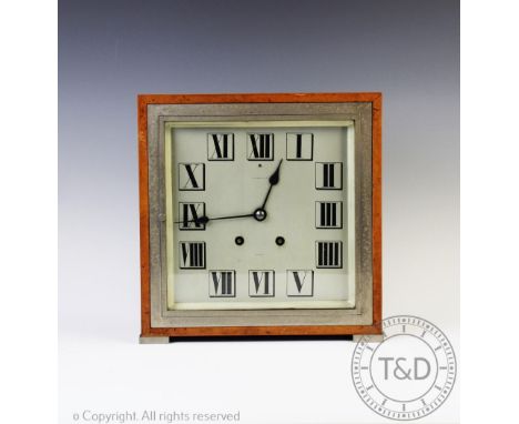 An Art Deco chrome and amboyna eight day mantel clock retailed by Tiffany and Co, the square dial with Roman numerals and sig