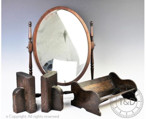 An early 20th century oak stool with cabriole legs, 36cm H with a skeleton framed toilet mirror, an oak book trough and two o