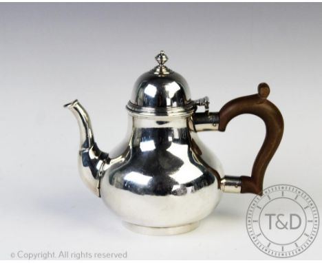 A silver bachelor's teapot Goldsmiths &amp; Silversmiths Co Ltd, London 1939, of squat bulbous form, with domed, hinged cover