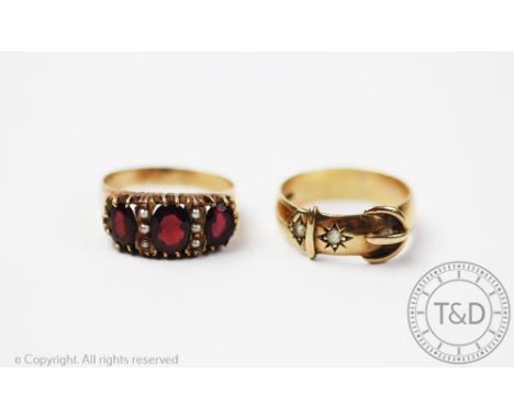 A 9ct yellow gold buckle ring, weight 4.9gms, size T/U and a garnet and seed pearl set ring in 9ct yellow gold, size U/V, gro