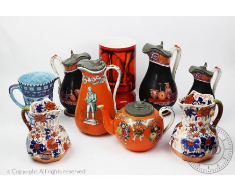 A Charlotte Rhead tulip pattern jug 16cm high, a Poole Pottery Delphis pattern cylindrical vase 23cm high, two Masnon's Paten
