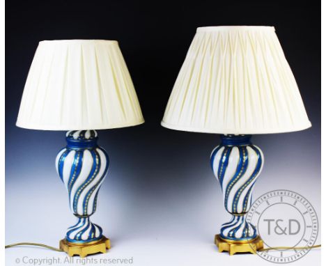 A pair of French porcelain lamp bases, 20th century, each of baluster, wrythen form and glazed in alternating turquoise and w