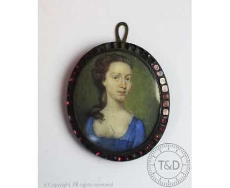 English School - 18th century, Watercolour portrait miniature - possibly on ivory, Portrait of a lady in a blue dress, 3.75cm