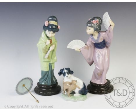 Two Lladro figures of geisha, one holding two fans, 29cm high, the other with a parasol, 28cm high, with a Nao group of a dog