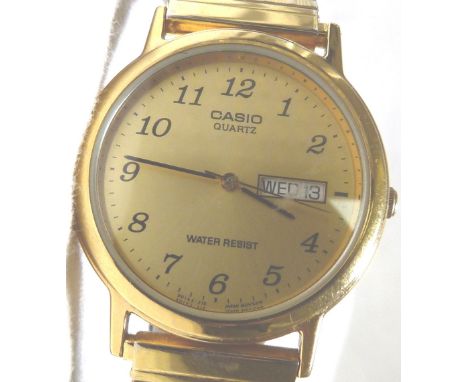 CASIO QUARTZ WRISTWATCH. Gold plated Casio quartz gents day date wristwatch on expanding strap