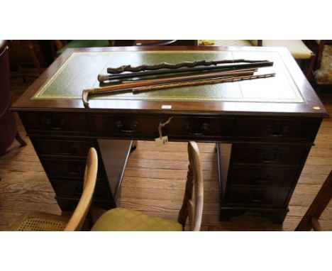 A Georgian-style mahogany twin pedestal desk with leather inset top, nine drawers under with swan neck brass drop handles on 