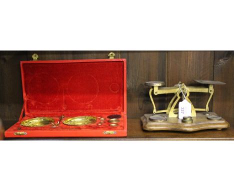 A Victorian brass Post Office weighing scales on a bow fronted oblong mahogany base, together with a cased jeweller's portabl