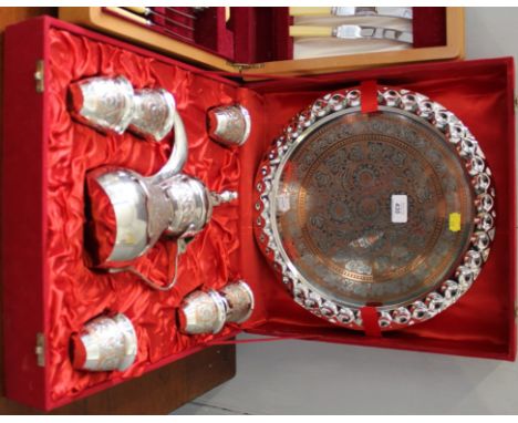 A Middle Eastern-style silver plated with copper tea service, comprising tea pot, tray and six cups in a lined presentation c