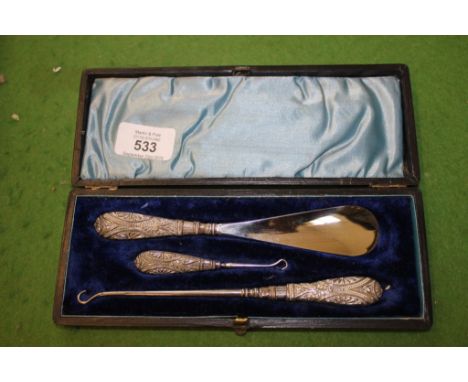 A cased set of silver handled shoe horn, two sizes of button hooks
