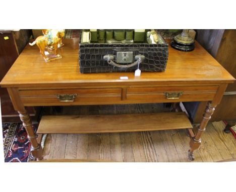 A late Victorian mahogany-framed wash stand with shaped top, two frieze drawers, brass drop handles and carved back plates, r