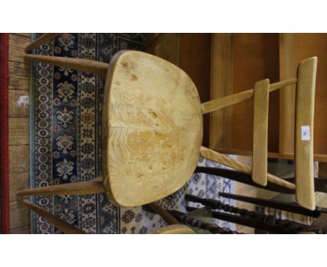 A set of four vintage Ercol stacking chairs with 'V' shaped supports, dished seats raised on splayed legs with stretcher supp