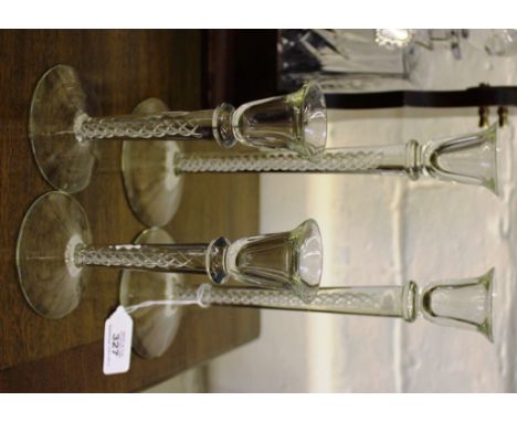 Two pairs of clear glass candlestick holders with rope twist stems