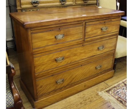 A late Victorian mahogany chest of two short and two long graduated drawers with shaped top, brass drop handles and carved ba