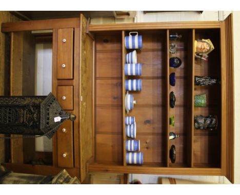 An old pine dresser with shaped cornice, fluted supports, three adjustable shelves with three frieze drawers with circular po