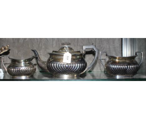 A three piece silver plated tea service, consisting tea pot, sugar bowl and milk jug 