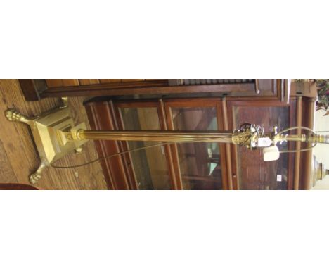A brass floor lamp with fluted Corinthian column on a square stepped base and claw feet, 145cm high