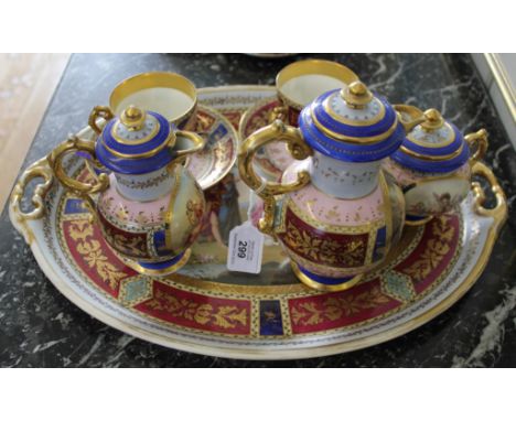 A late 19th century Viennese 'Tea for Two' service, consisting of two cups, two saucers, coffee pot, chocolate pot, sugar bow