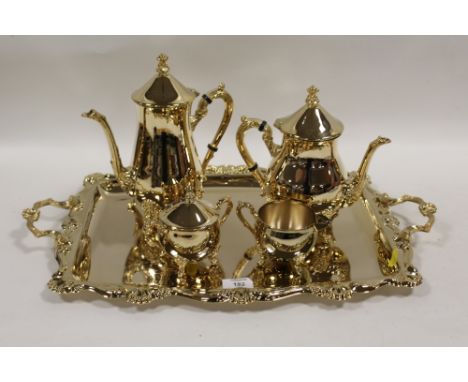 A GILDED METAL FOUR PIECE TEA SERVICE ON MATCHING TWIN HANDLED SERVING TRAY