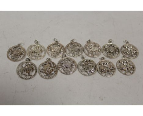 A BAG OF STERLING SILVER SIGNS OF THE ZODIAC PENDANTS 