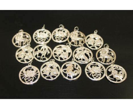 A BAG OF STERLING SILVER SIGNS OF THE ZODIAC PENDANTS 