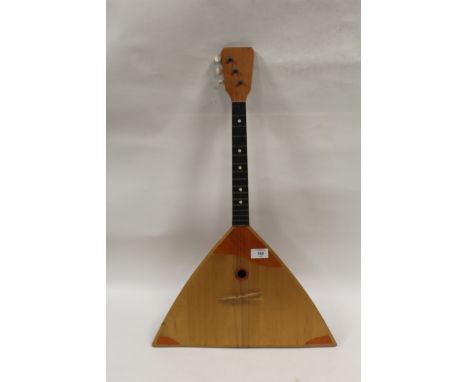 A THREE STRING LUTE STYLE STRING INSTRUMENT 